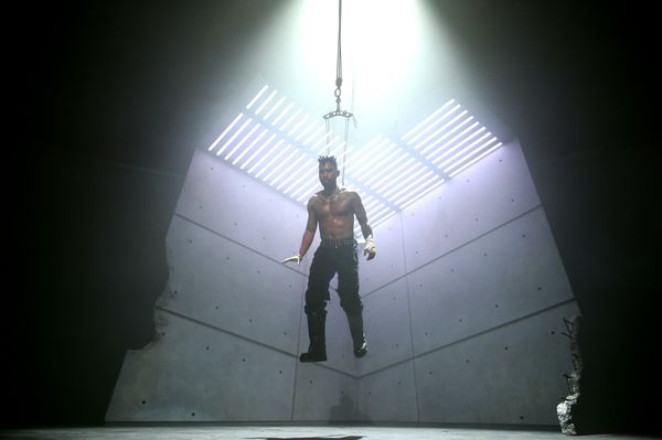 Miguel hanging by hooks in his back while performing "Rope" via body suspension