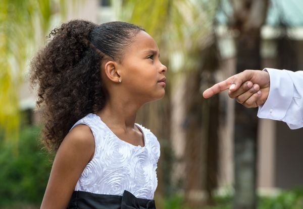 Parent disciplining his daughter