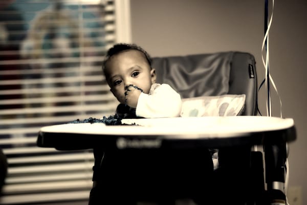 A toddler sitting in a high chair